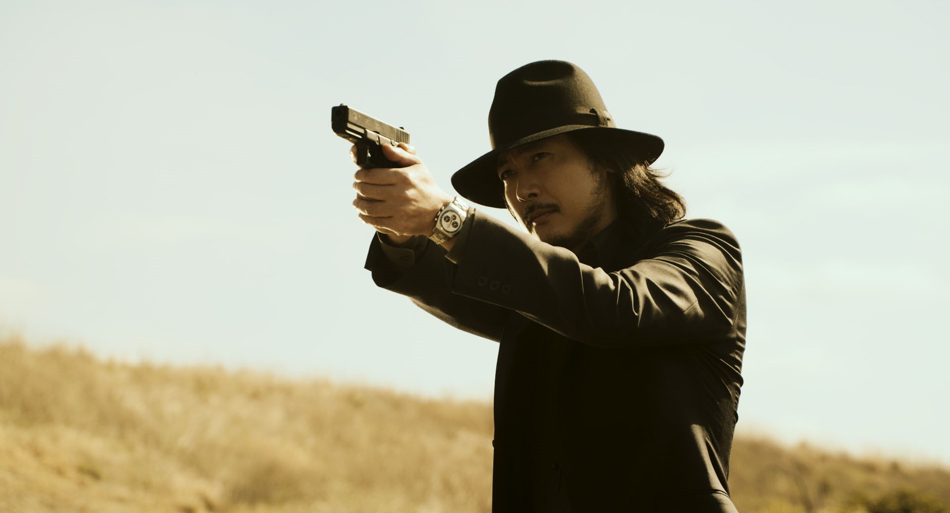 Tetsuji Tamayama as Daisuke Jigen, holding a pistol