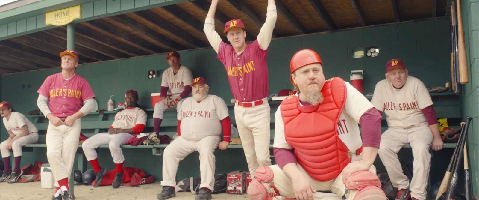 A group of middle-aged baseball players in the dugout in Eephus