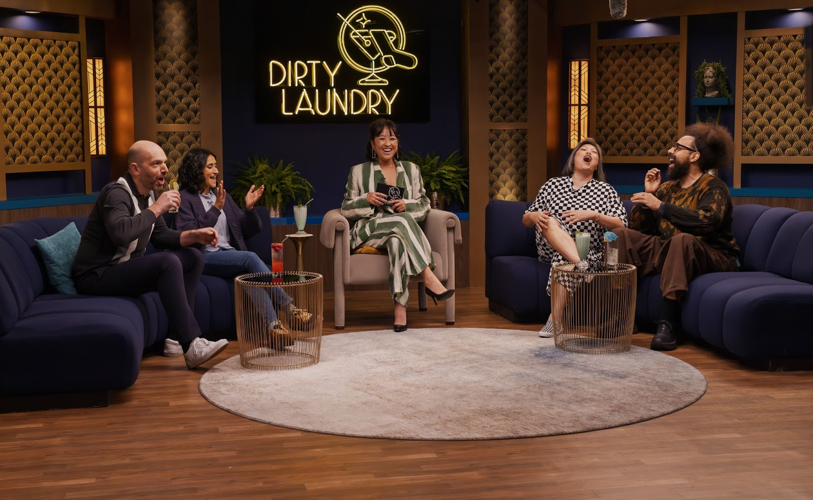 Lily Du and a group of guests laugh on the set of Dirty Laundry