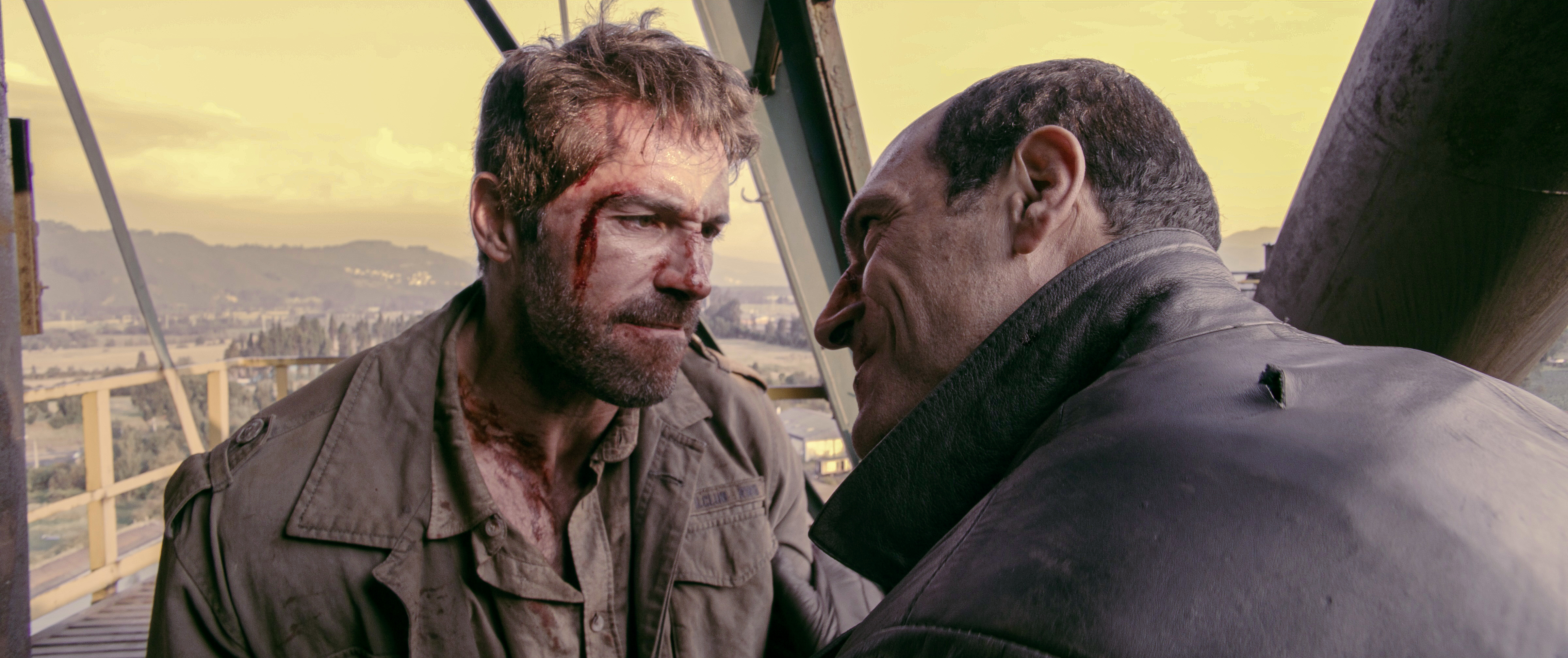 Scott Adkins and Marko Zaror, locked in battle face-to-face in a high area in Diablo