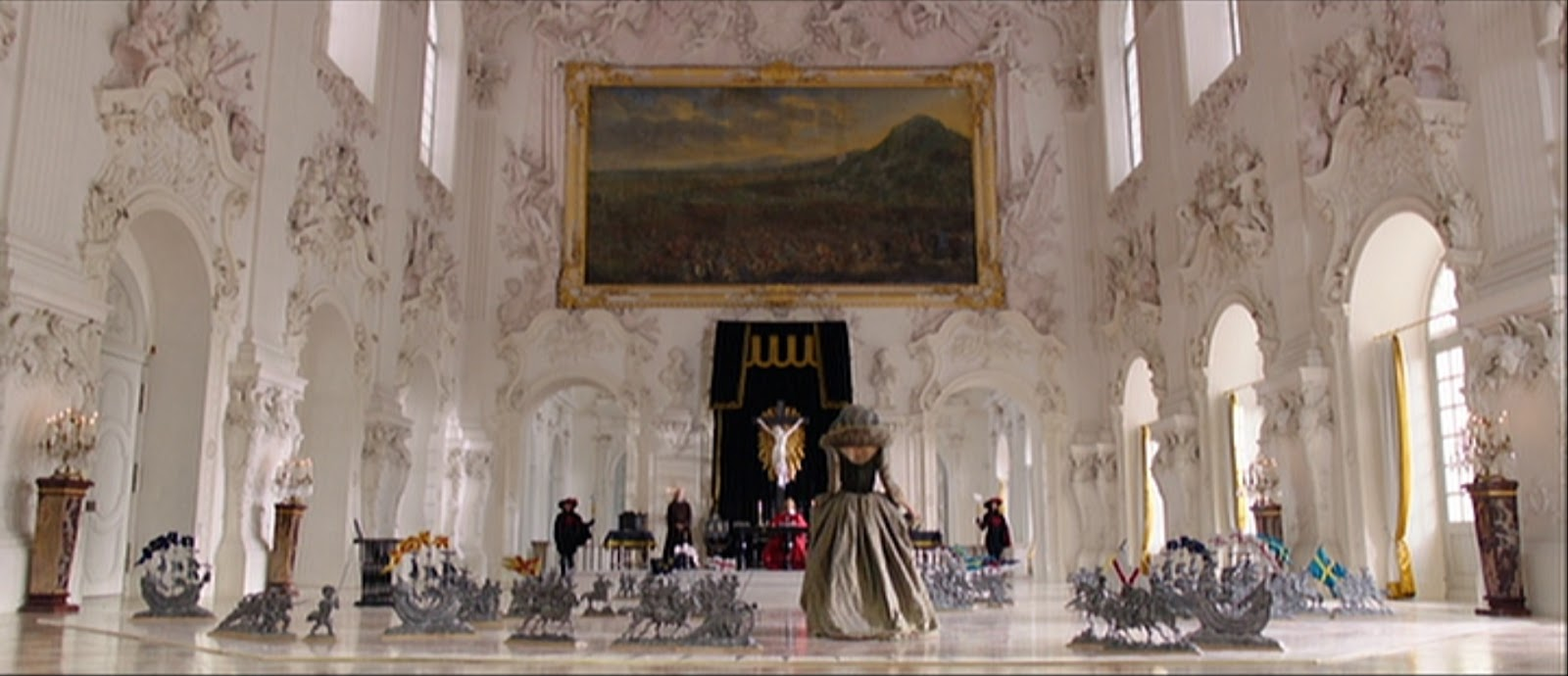 A large room in The Three Musketeers, with a giant painting and a throne