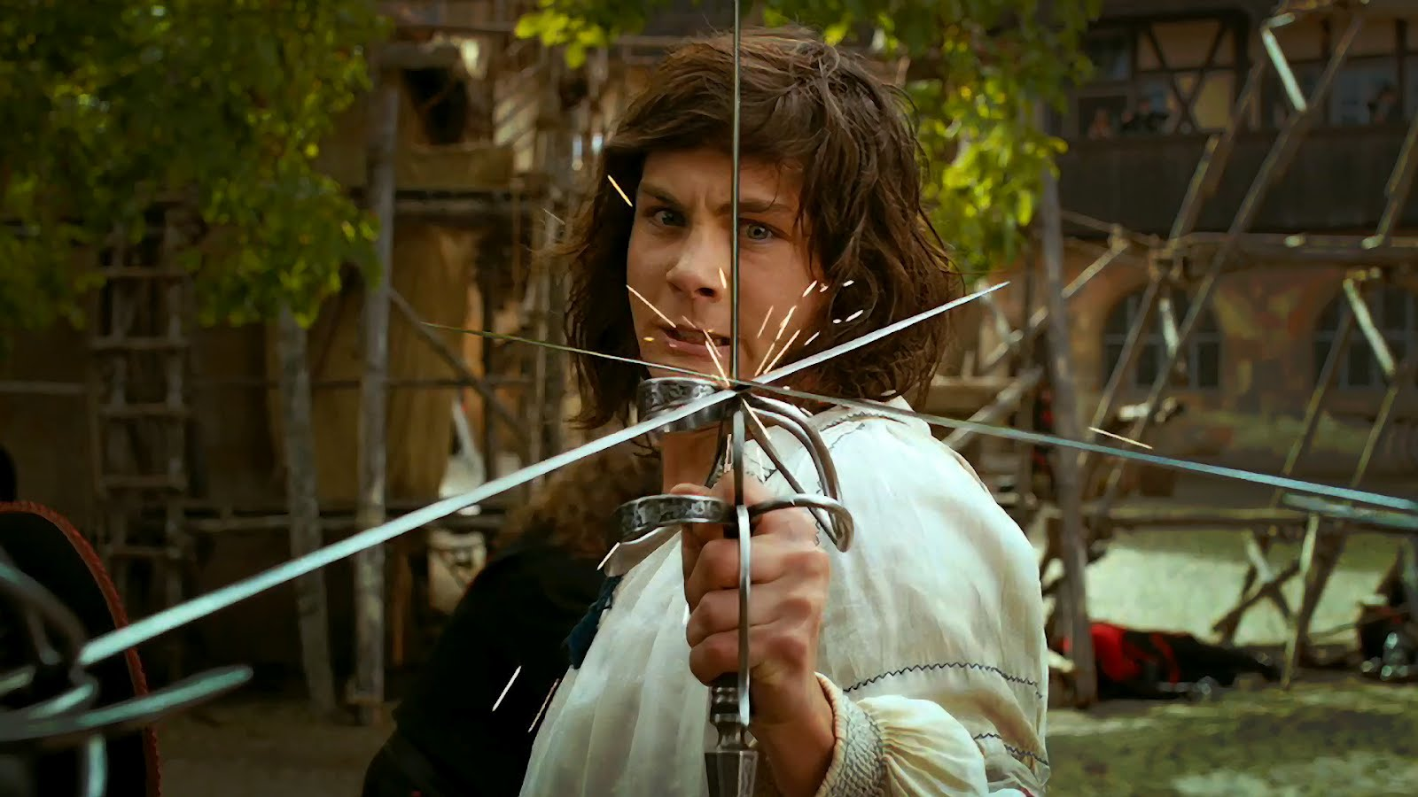 Logan Lerman blocks two swords at once in The Three Musketeers