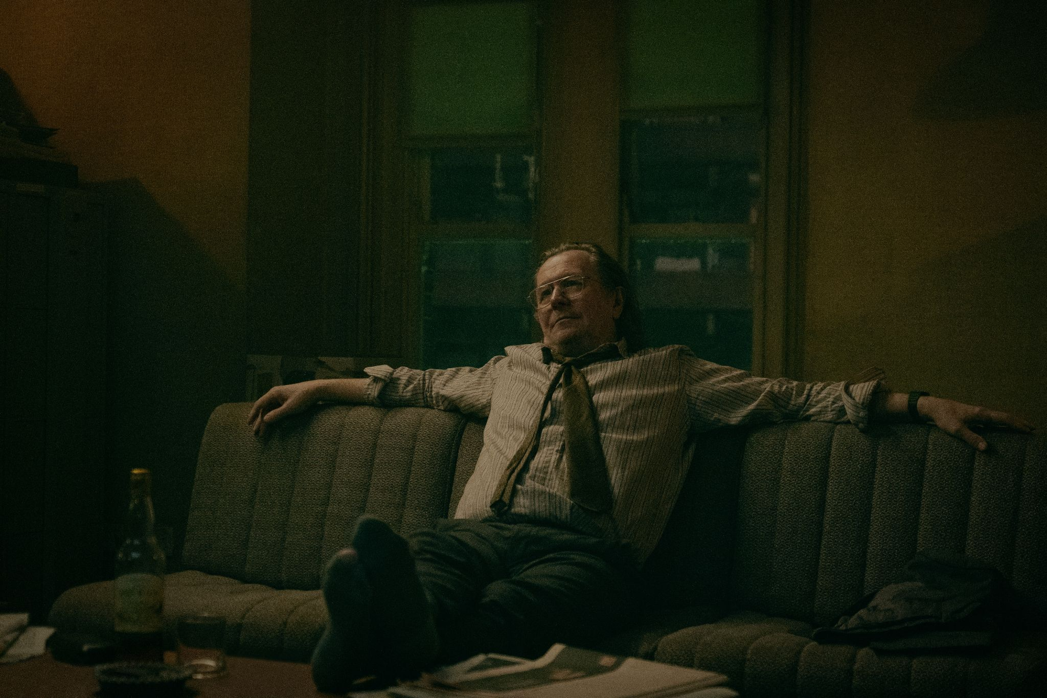 Gary Oldman chills on a couch in Slow Horses