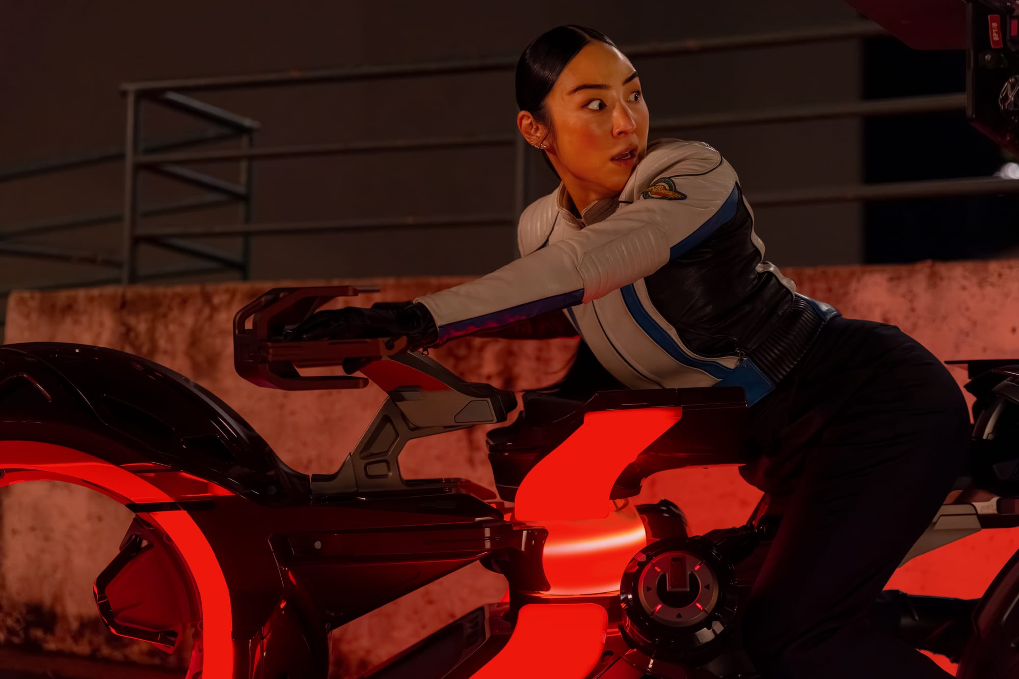 Greta Lee on a futuristic motorcycle in Tron Ares