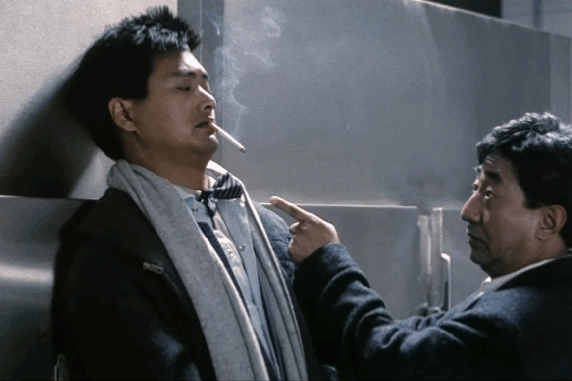 Chow Yun-fat, cigarette dangling out of his mouth, gets lectured by his commanding officer in City on Fire