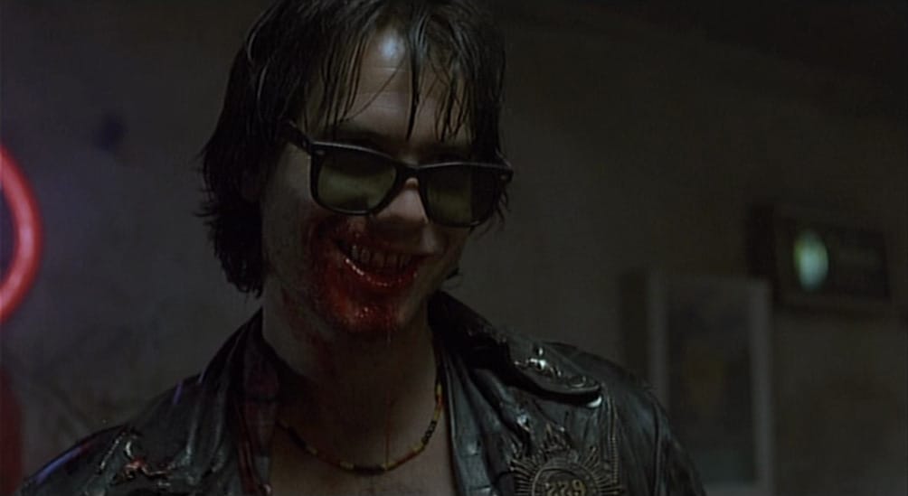 Sexy vampire Bill Paxton smiles with blood on his mouth
