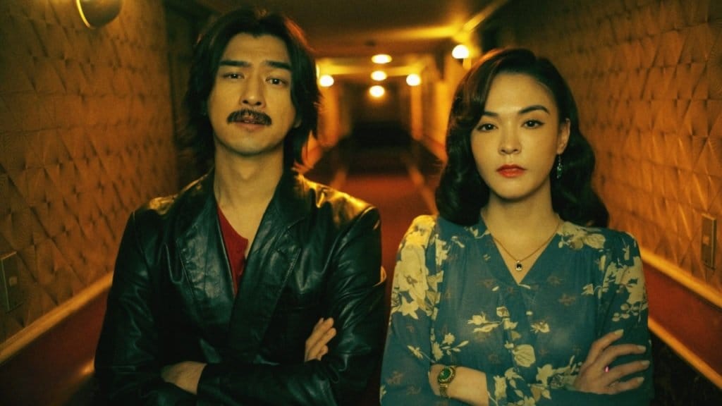 Sandrine Pinna and Chen Bolin stand in a hallway, arms crossed, in Dead Talents Society