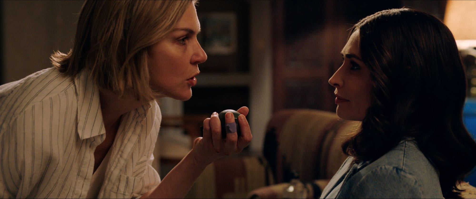 Carol holds a grenade while talking to Zosia in Pluribus