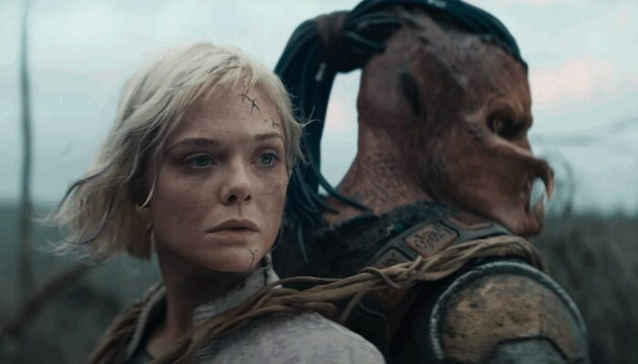 Android Elle Fanning on Predator Dimitrios Schuster-Koloamatangi's back in Predator: Badlands