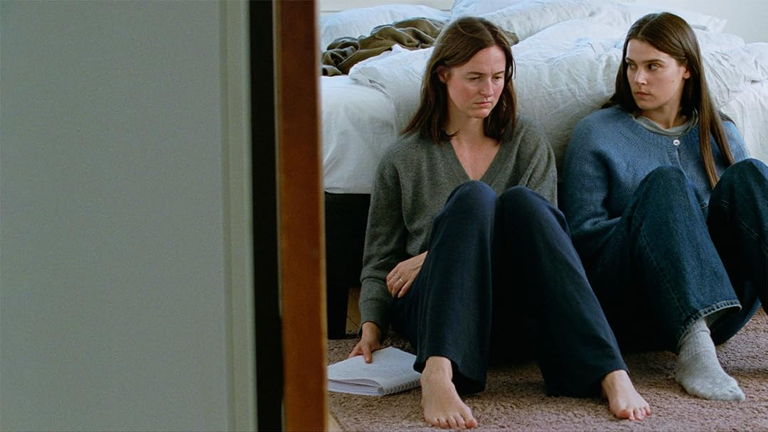 Renate Reinsve and Inga Ibsdotter Lilleaas sit next to each other on a bedroom floor in Sentimental Value