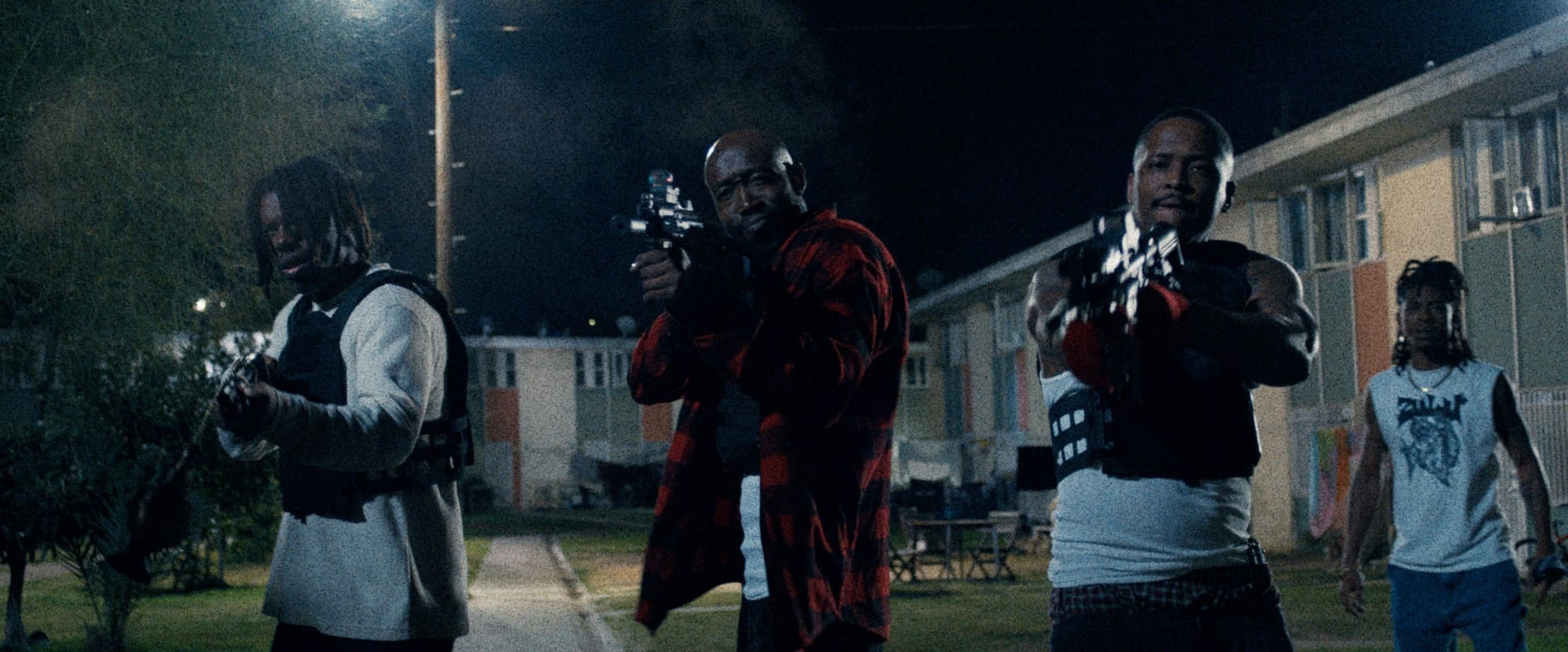 Flying Lotus, Freddie Gibbs, and YG hold sub-machine guns in Night Patrol while RJ Cyler looks on