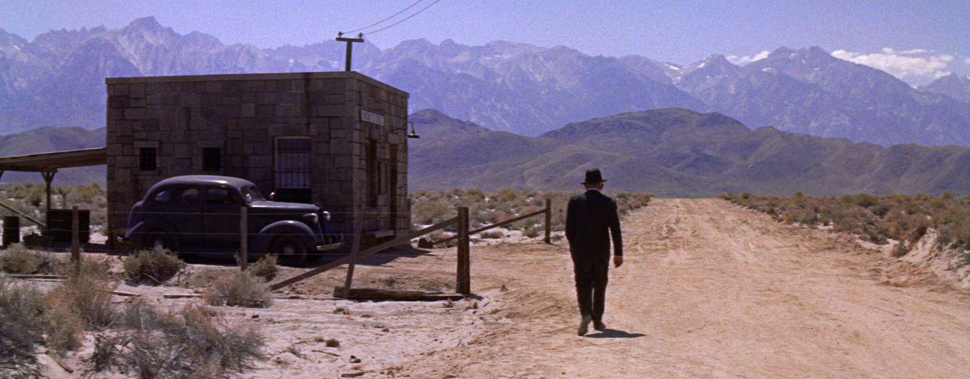 Spencer Tracy walks on a long dirt road in Bad Day at Black Rock