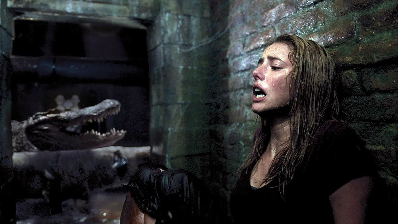 Kaya Scodelario hides from an alligator in Crawl