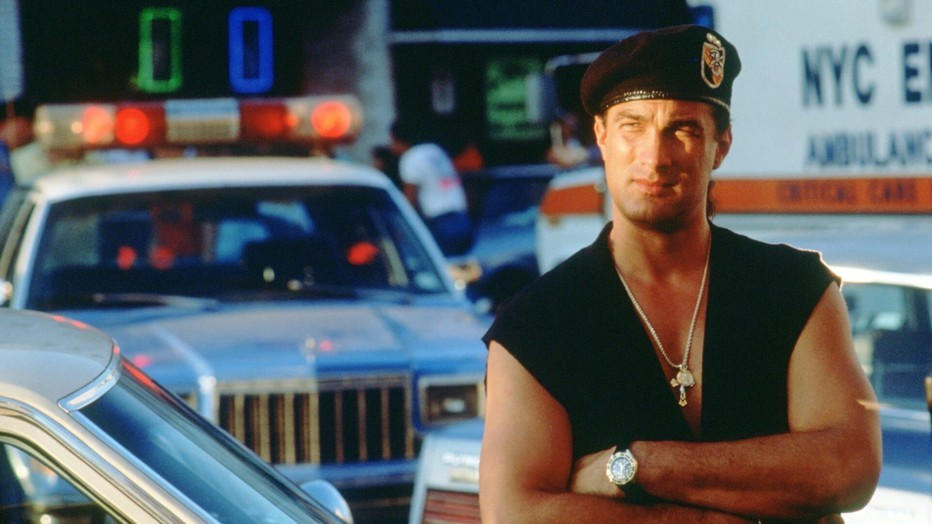 Steven Seagal crosses his arms and smirks in Out for Justice