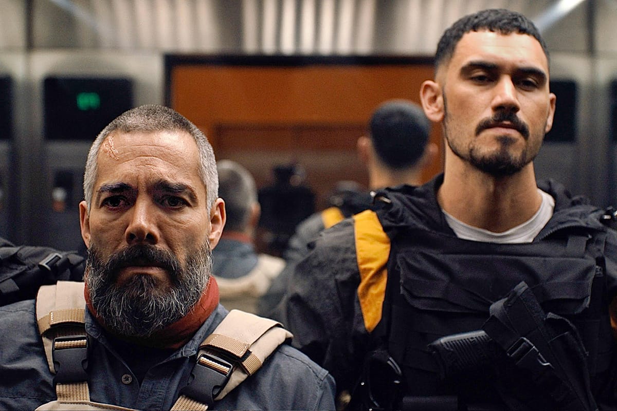 The two leads in Vengeance, geared up and on an elevator