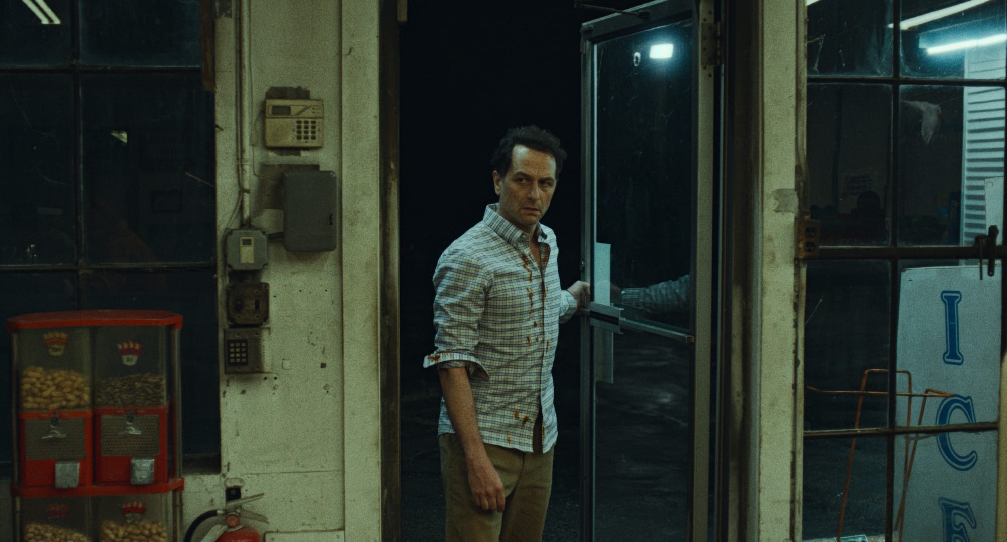 Matthew Rhys enters a convenience store in Widow's Bay
