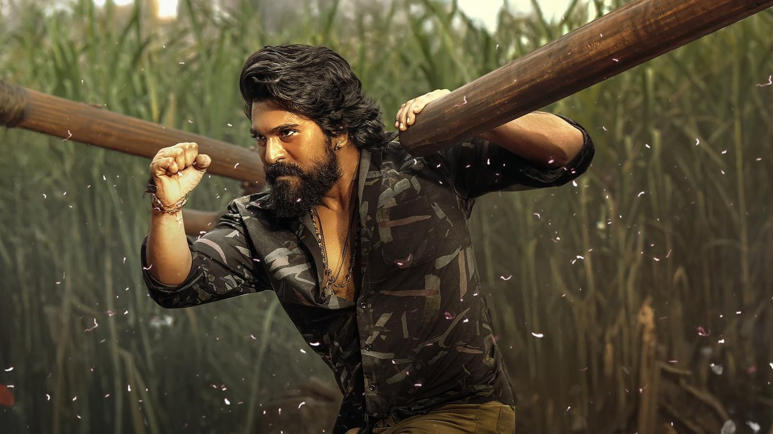 Ram Charan dramatically breaking through a wooden barrier in Peddi