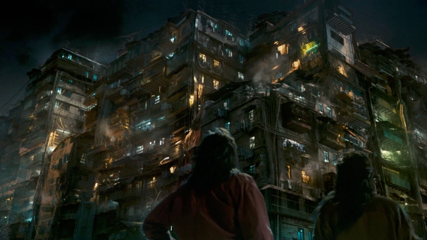 Two people look at the massive, sprawling Kowloon Walled City in Twilight of the Warriors: Walled In
