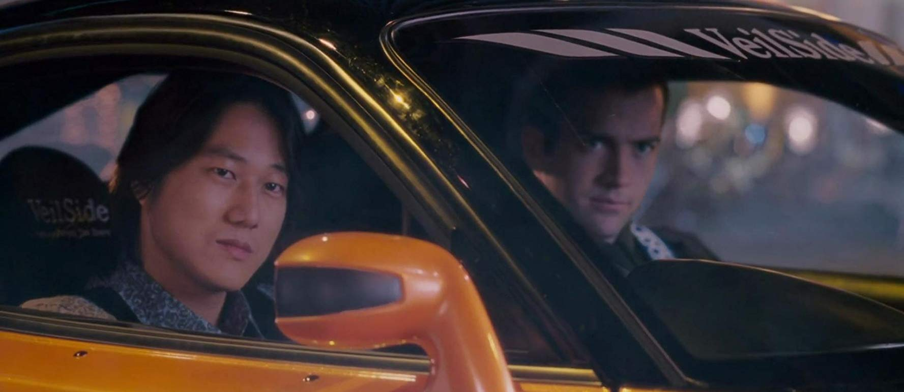 Sung Kang and Lucas Black in a sports car in Tokyo Drift