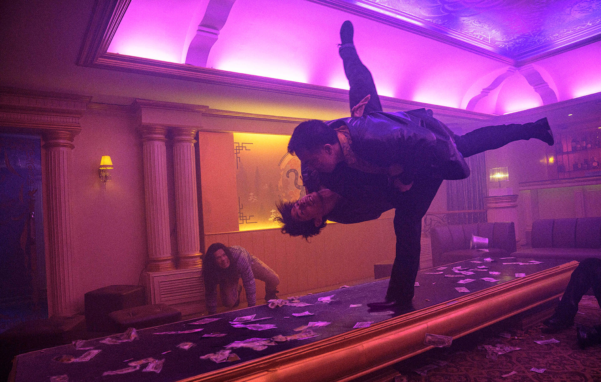 Joe Taslim tosses a man on his head on top of a table in The Furious