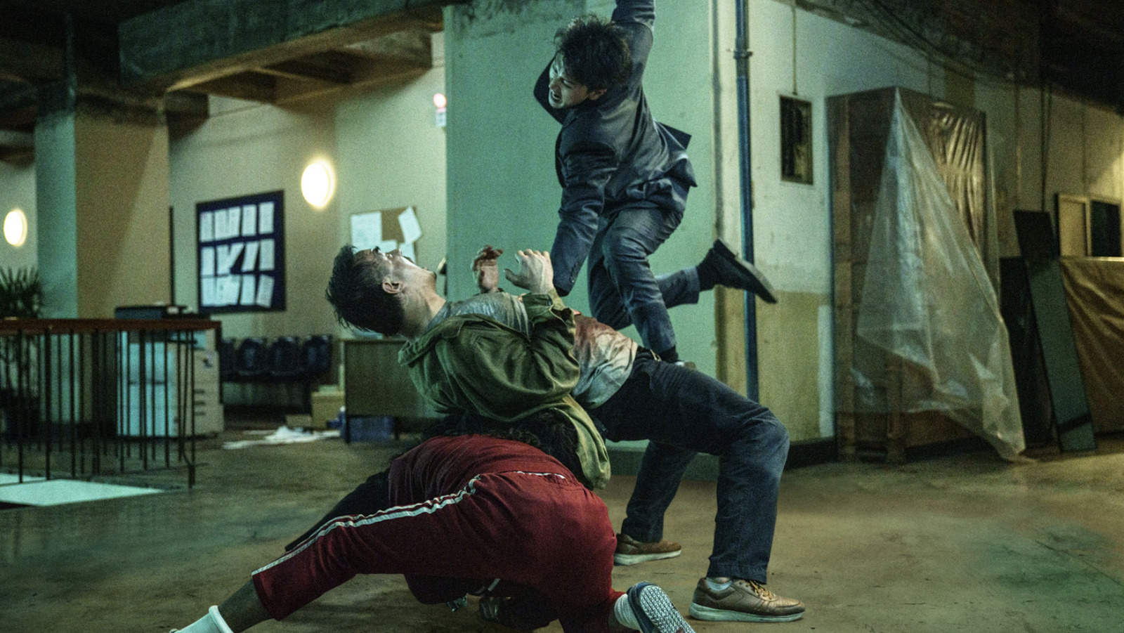 A pile of bodies in The Furious, as Joey Iwanaga takes a jumping blow towards Joe Taslim
