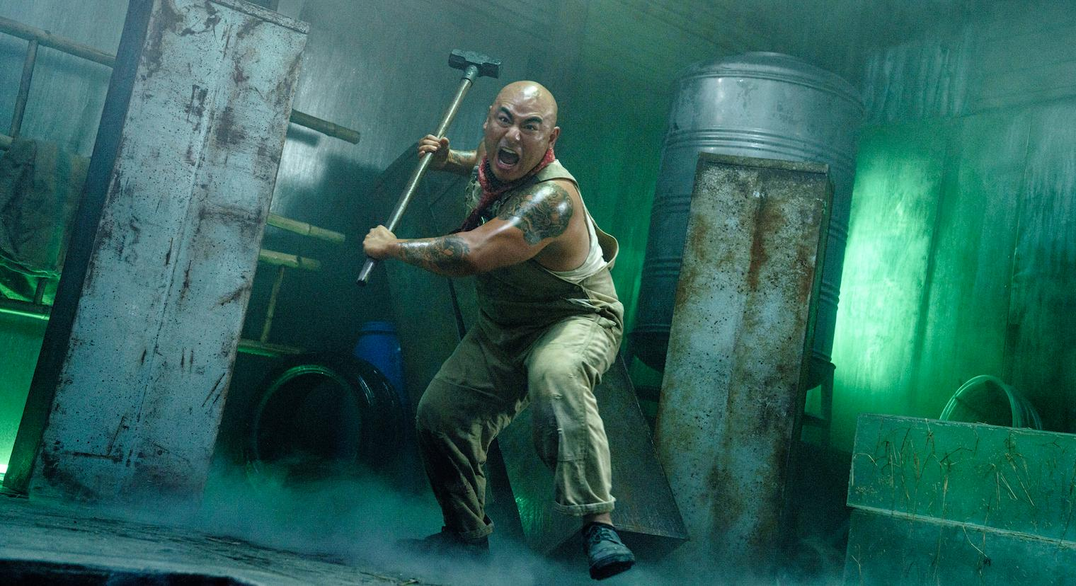 Brian Le looking big and scary and carrying a big hammer in The Furious