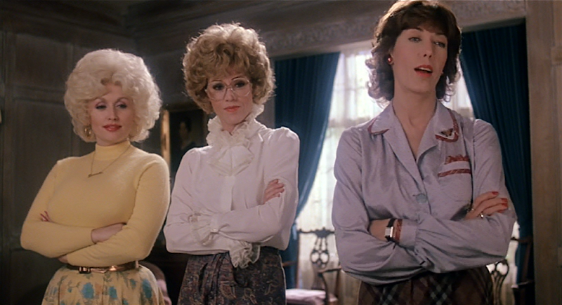 Dolly Parton, Jane Fonda, and Lily Tomlin cross their arms in 9 to 5