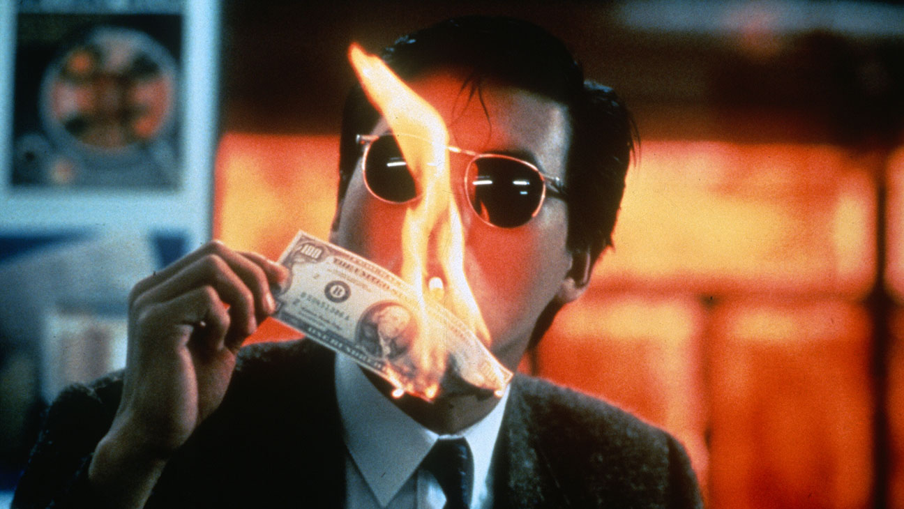 Chow Yun-fat lights his cigarette with a flaming $100 bill in A Better Tomorrow
