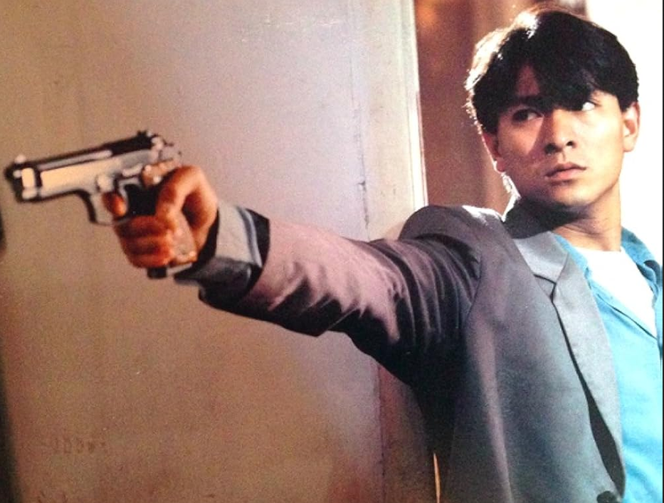 Andy Lau points a gun in Hong Kong Godfather