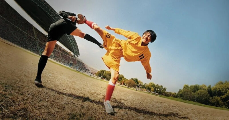 A soccer player executes a high kick on another soccer player in Shaolin Soccer