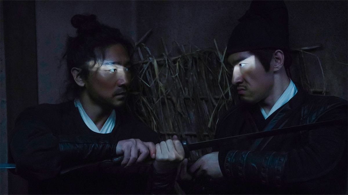 Two swordsmen fight in The Butcher's Blade, a sliver of light shining on each of their eyes