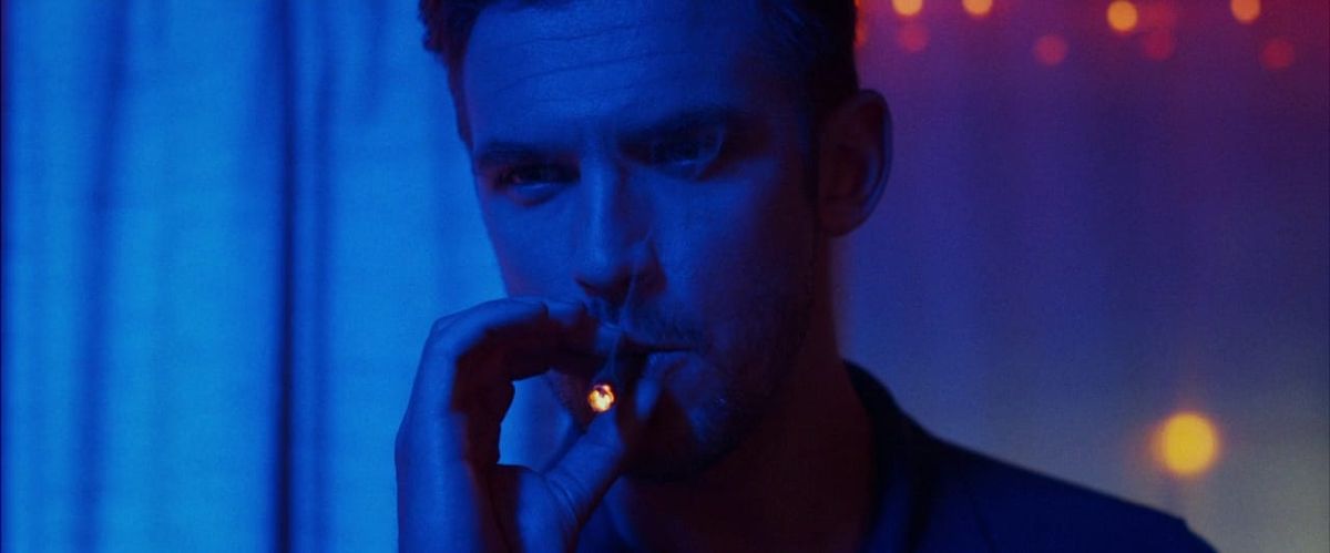 Dan Stevens lighting up in The Guest