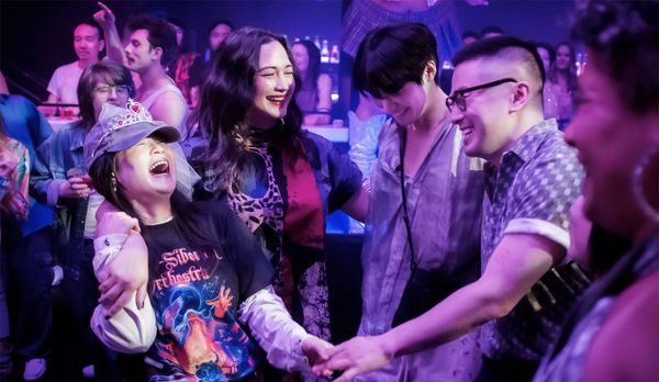 The leads of The Wedding Banquet remake dance together at a club