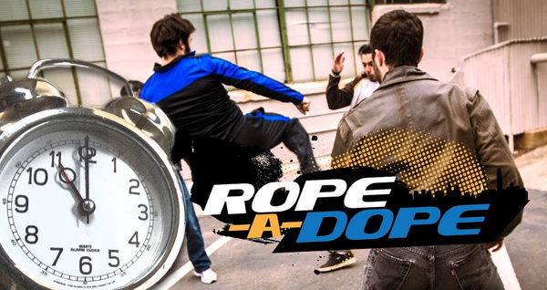 Teaser image for Rope-A-Dope, featuring three men fighting in an alleyway, the title, and an alarm clock