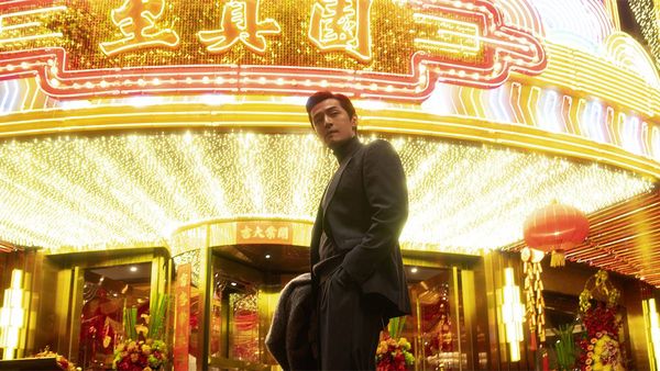 Hu Ge looking very cool in front of a lit-up marquee in Blossoms Shanghai