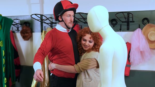 Ania Magliano hugs Alex Horne (wearing a jockey outfit) next to a mannequin in Taskmaster
