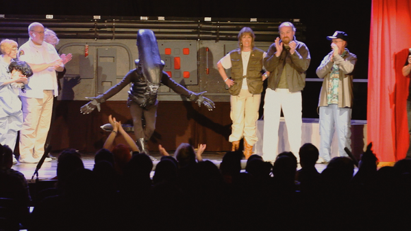 In Alien on Stage, the crew of the Nostromo claps on stage as the Xenomorph bows to a cheering audience