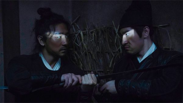 Two swordsmen fight in The Butcher's Blade, a sliver of light shining on each of their eyes