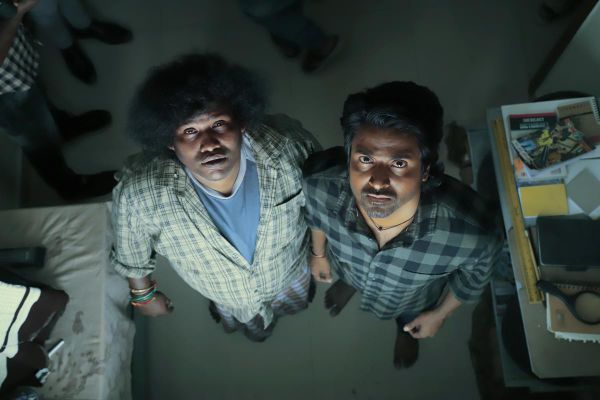Sivakarthikeyan and Yogi Babu look up at the camera (or perhaps an omniscient voice????) in Maaveeran