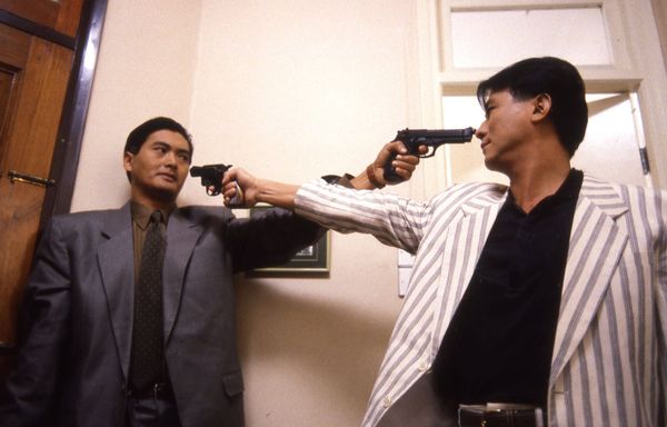 Chow Yun-fat and Ti Lung point guns at each other in A Better Tomorrow