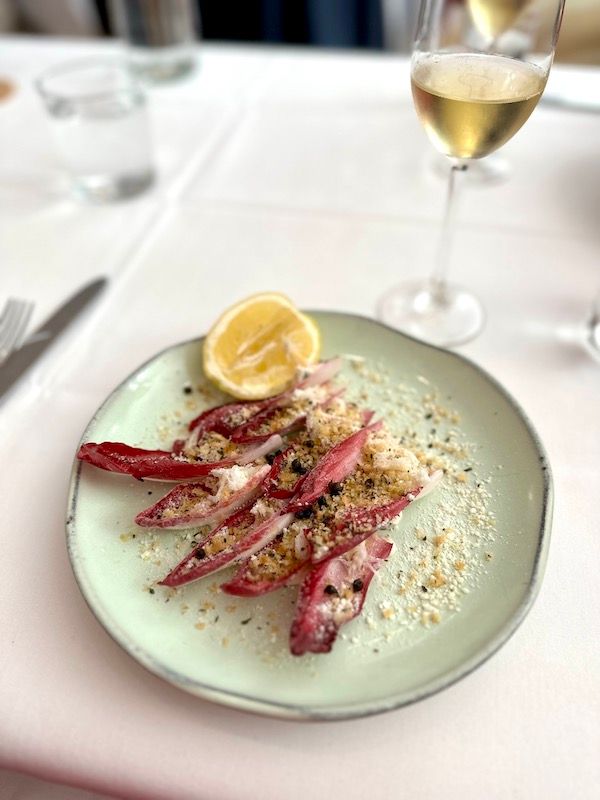 Dungeness crab with red endive, granch, and mizithra at brunch at Estiatorio Ornos