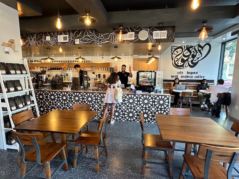 friendly staff waving at Haraz Coffee.