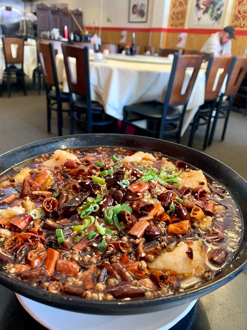 Big bowl of fish cooked in flaming chile oil at Chili House. 