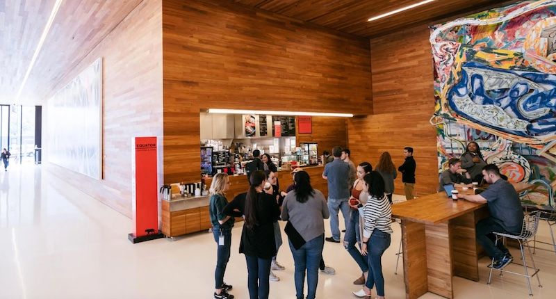 People standing in a lobby at Equator Coffees SOMA location