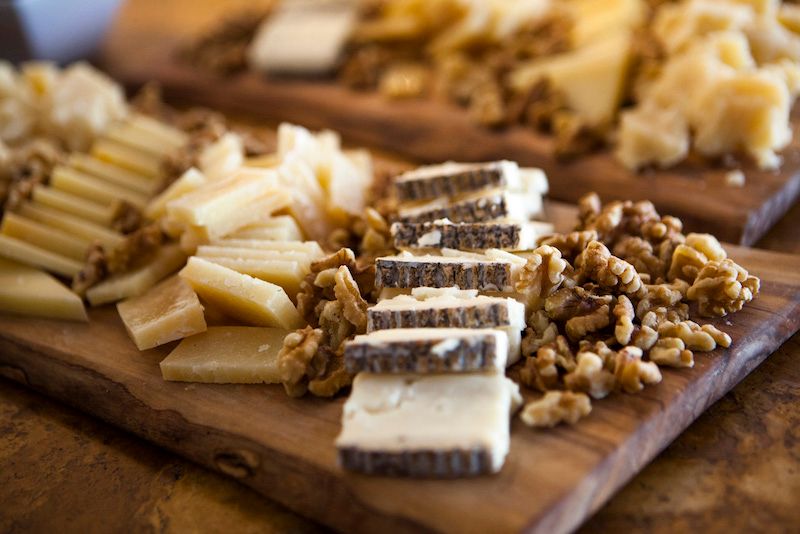 sliced cheeses and walnuts for an event at Donato Enoteca