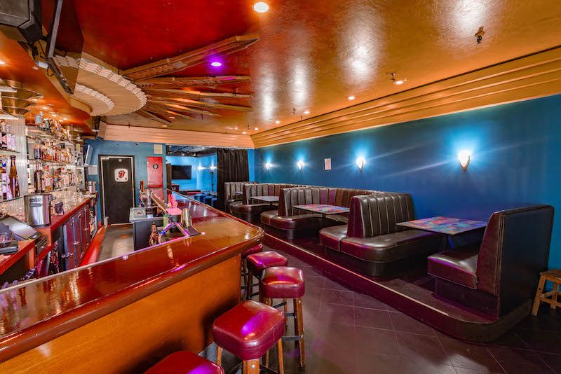 The Bar at 312 Harriet and booths with a blue wall and Art Deco bar