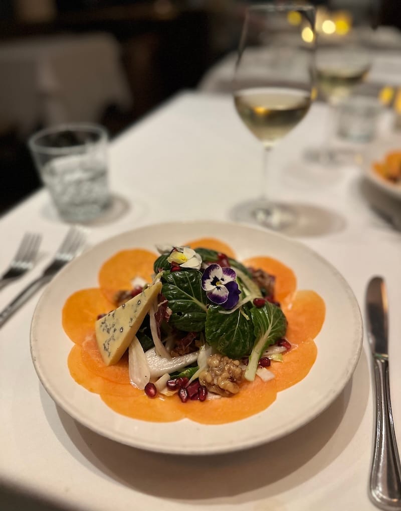Fuyu persimmon and chicory salad with Grazin Girl blue cheese, tatsoi, pomegranate, and toasted walnut vinaigrette.