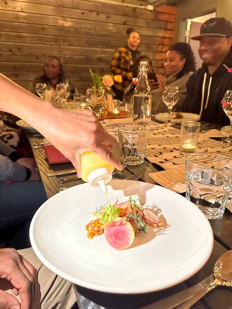 a course e le ade Test Kitchen x Brundo Spice Kitchen pop-up dinner: asa gored gored made with hamachi, mitmita togarashi, radish, and coconut broth.