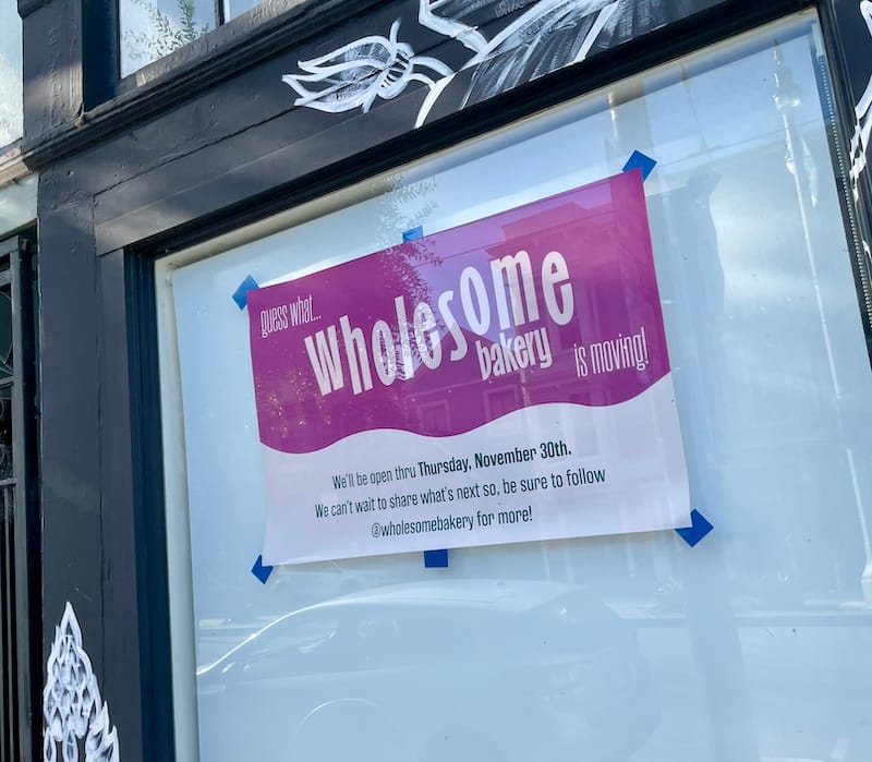 sign in the window at Wholesome Bakery saying they are moving