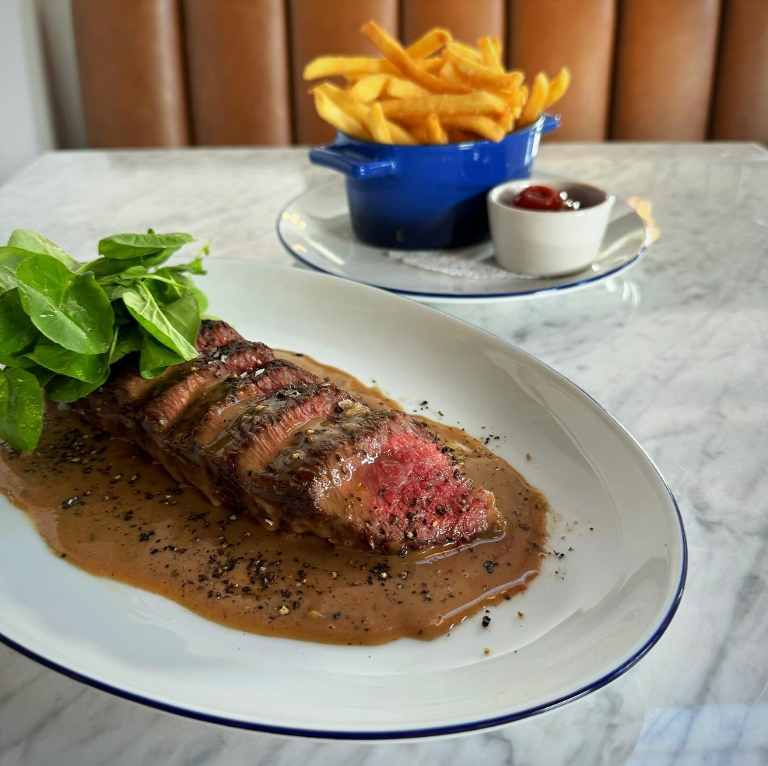 Steak frites with Australian wagyu sirloin, black pepper and brandy au poivre sauce, and hand-cut frites at Tangerine Bistro. Instagram photo via @tangerinetahoe.